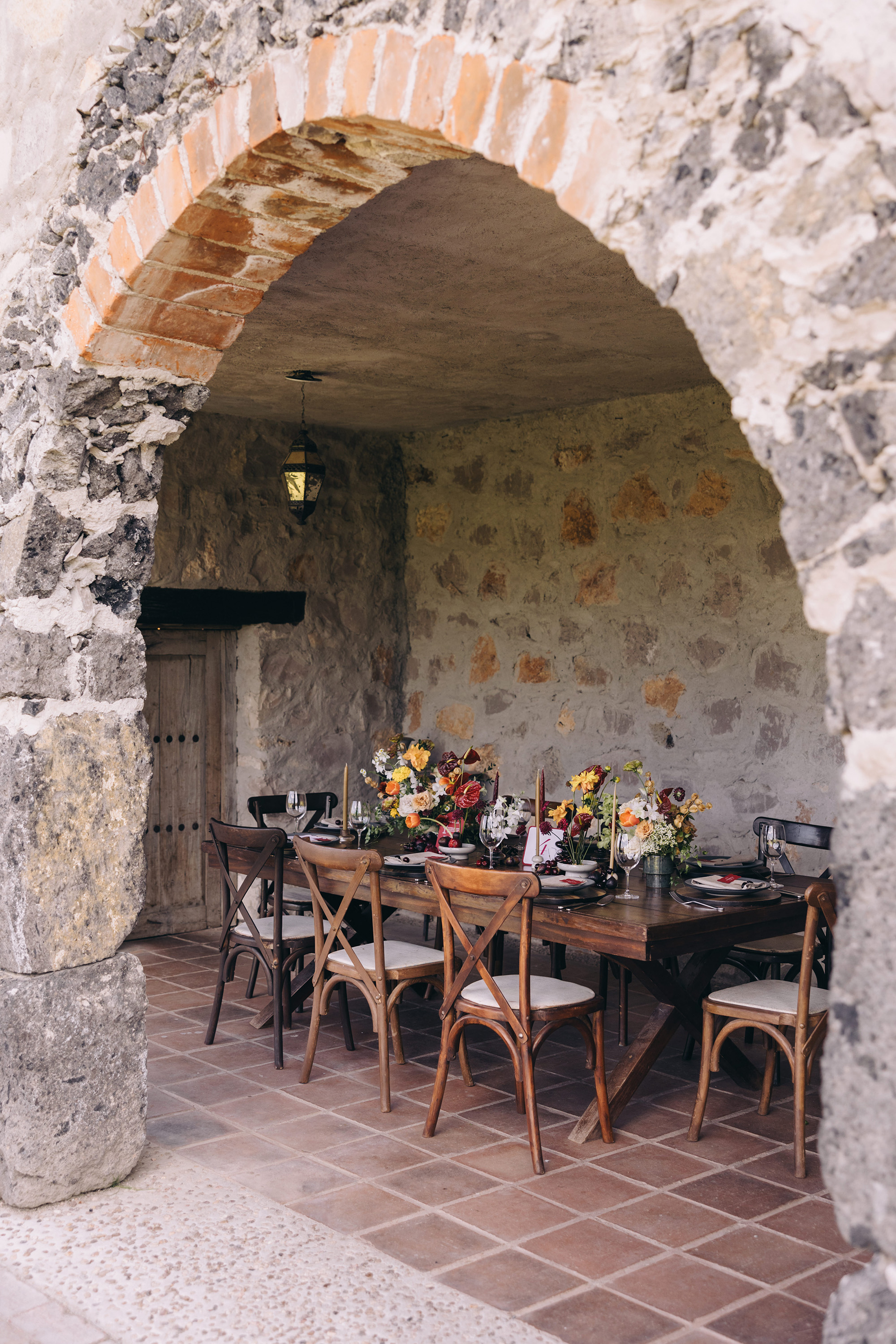 A set table beneath a stone arch